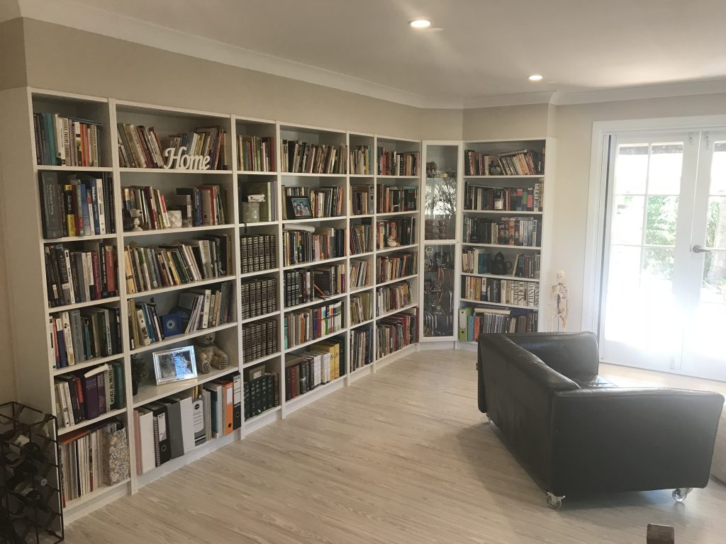 Floor-to-ceiling built-in library shelving in a Brisbane living room