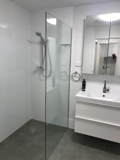 Modern bathroom with frameless walk-in shower and double vanity